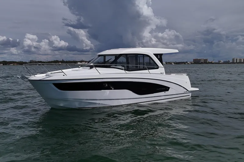 The Image of 2026 Beneteau Antares 9 V2 boat on calm water under cloudy sky. - 0