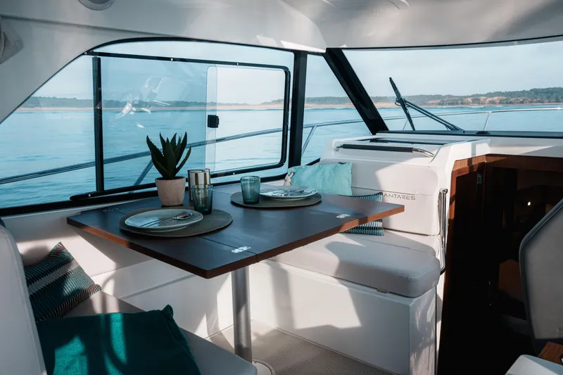 Slide: The Image of Interior of 2026 Beneteau Antares 9 V2 yacht with dining area and scenic window view. - 28