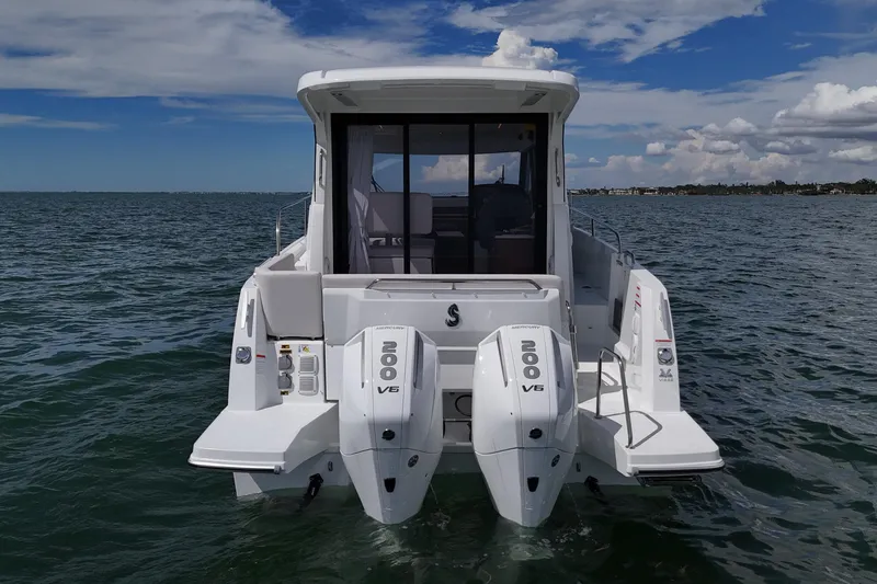 Slide: The Image of 2026 Beneteau Antares 9 V2 boat with twin 200 V6 engines on open water. - 3