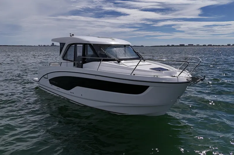 Slide: The Image of 2026 Beneteau Antares 9 V2 boat on calm ocean waters under a partly cloudy sky. - 6