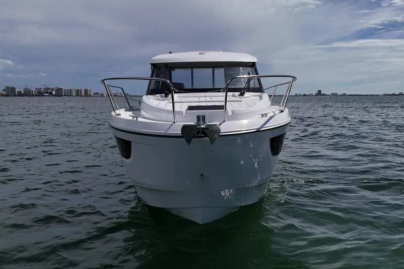 Slide: The Image of 2026 Beneteau Antares 9 V2 boat on open water, city skyline in background. - 7