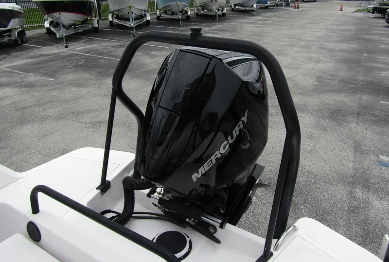 Slide: The Image of 2022 Axopar 22 T-Top with Mercury outboard engine in a parking lot. - 20
