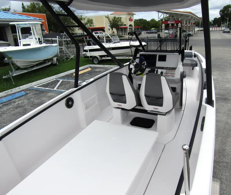 Slide: The Image of 2022 Axopar 22 T-Top boat interior with dual seats and modern dashboard. - 22