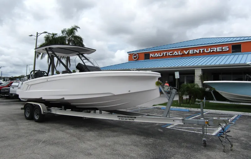 Slide: The Image of 2022 Axopar 22 T-Top boat on trailer outside Nautical Ventures dealership. - 4