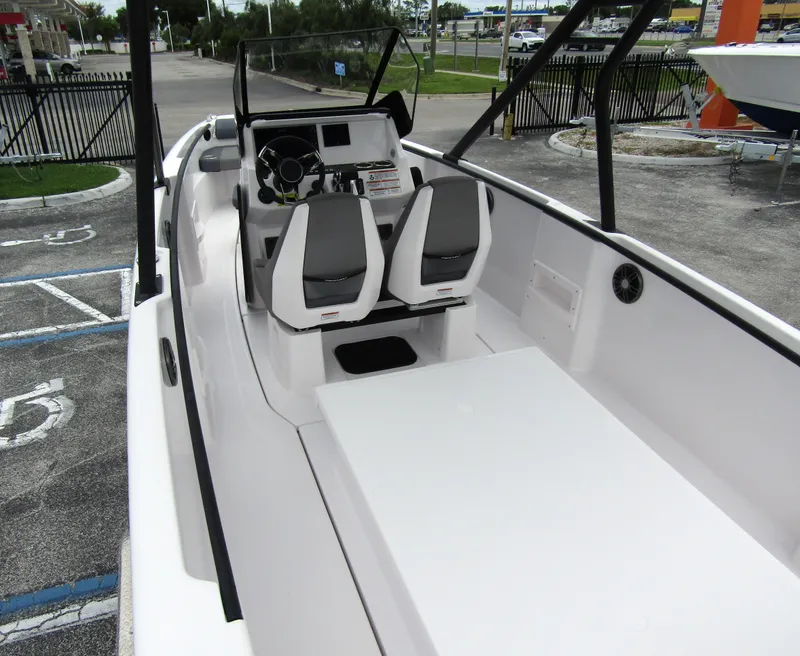 Slide: The Image of 2022 Axopar 22 T-Top boat interior with dual seats and steering console. - 21