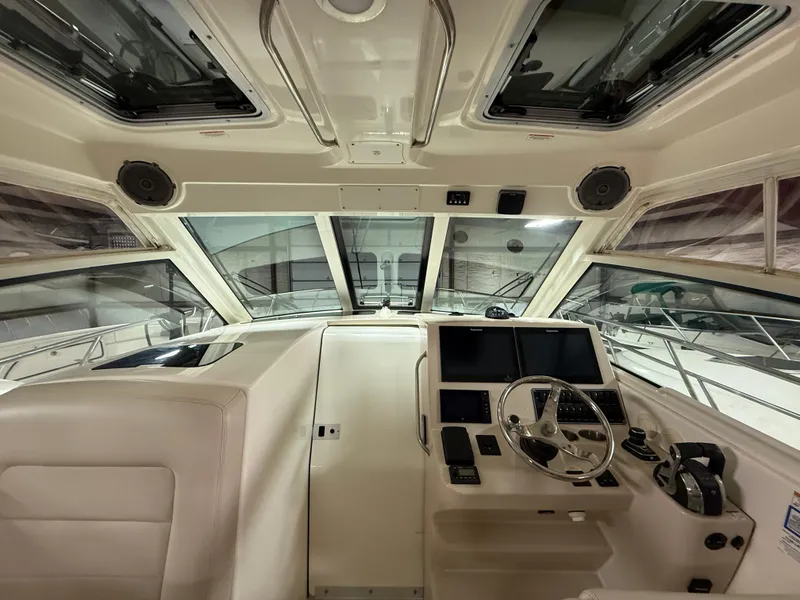 Slide: The Image of 2018 Boston Whaler 345 Conquest helm with modern navigation equipment and panoramic windows. - 10