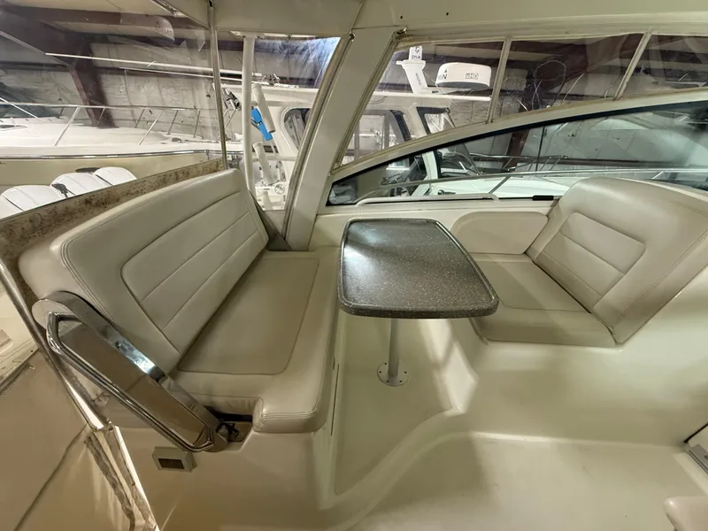 Slide: The Image of 2018 Boston Whaler 345 Conquest interior with seating and table in cabin area. - 11
