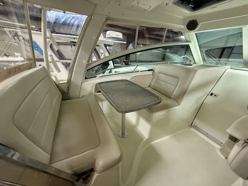 Slide: The Image of Interior of 2018 Boston Whaler 345 Conquest, featuring seating and table. - 12