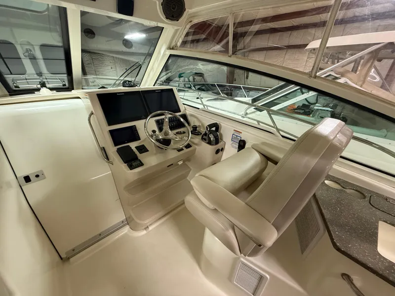 Slide: The Image of 2018 Boston Whaler 345 Conquest helm with modern controls and comfortable seating. - 13