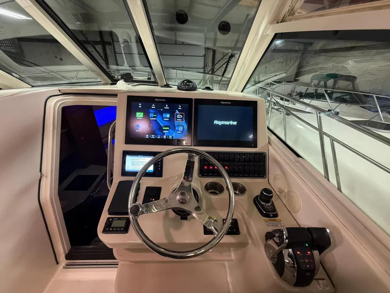 Slide: The Image of Helm of 2018 Boston Whaler 345 Conquest with advanced navigation displays and controls. - 14