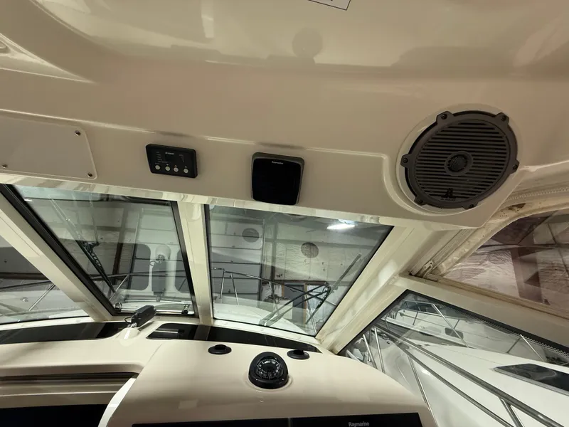 Slide: The Image of Interior view of 2018 Boston Whaler 345 Conquest boat cockpit with speaker and controls. - 15