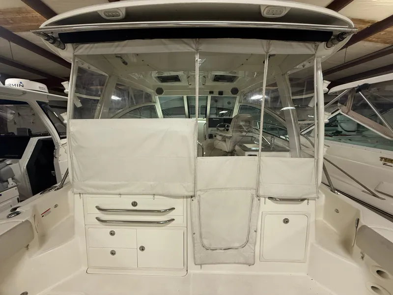 Slide: The Image of 2018 Boston Whaler 345 Conquest boat interior with covered cockpit and storage compartments. - 6