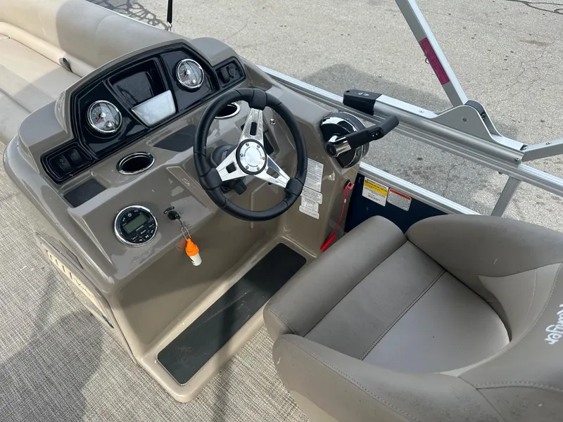 Slide: The Image of 2023 Ranger Reata 200C boat dashboard with steering wheel and controls. - 13