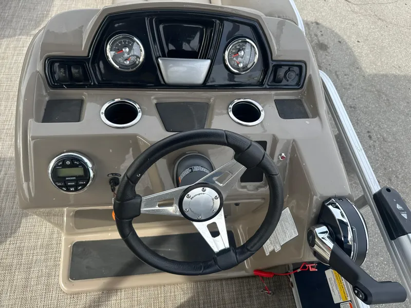 Slide: The Image of 2023 Ranger Reata 200C boat dashboard with steering wheel and control panel. - 14