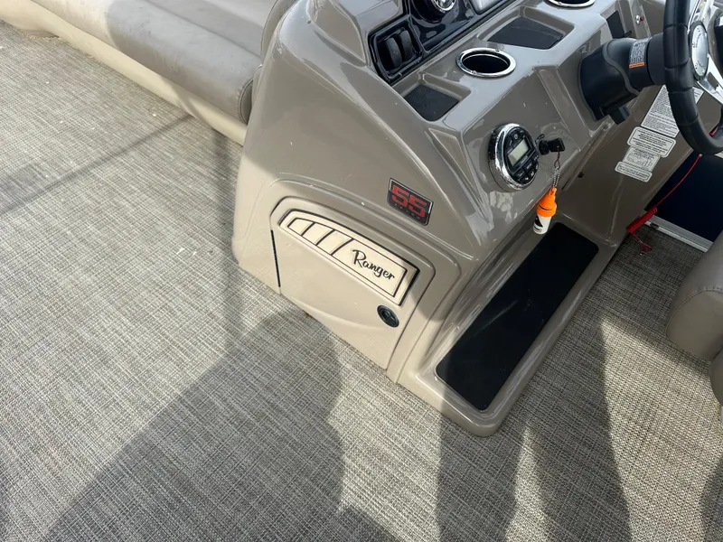 Slide: The Image of 2023 Ranger Reata 200C boat console with steering wheel and controls. - 15