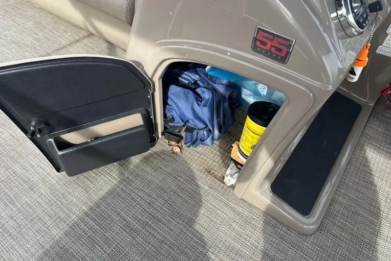 Slide: The Image of Open storage compartment in 2023 Ranger Reata 200C boat with gear and supplies. - 16