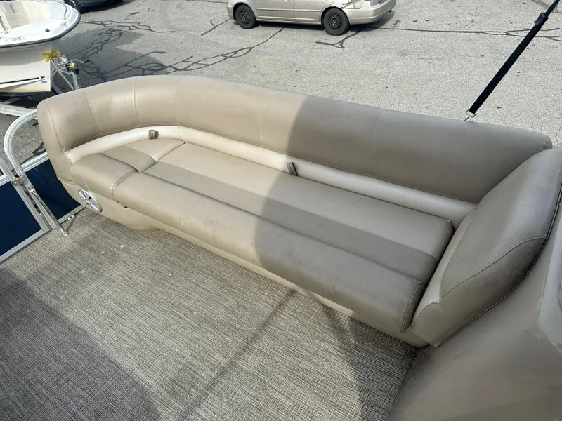Slide: The Image of 2023 Ranger Reata 200C boat with beige seating on a textured deck. - 20