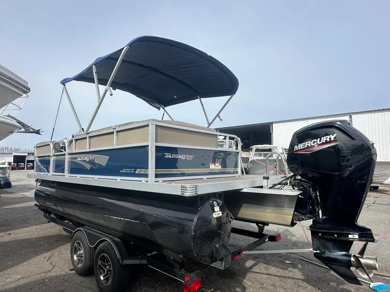 Slide: The Image of 2023 Ranger Reata 200C pontoon boat with Mercury outboard motor on trailer. - 5