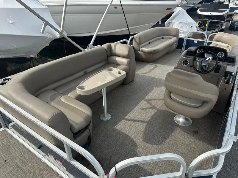 Slide: The Image of 2023 Ranger Reata 200C pontoon boat with spacious seating and modern helm. - 8