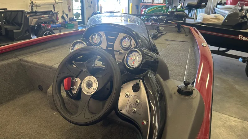 Slide: The Image of 2020 Tracker PRO175TXW boat dashboard with steering wheel and gauges in a garage setting. - 5
