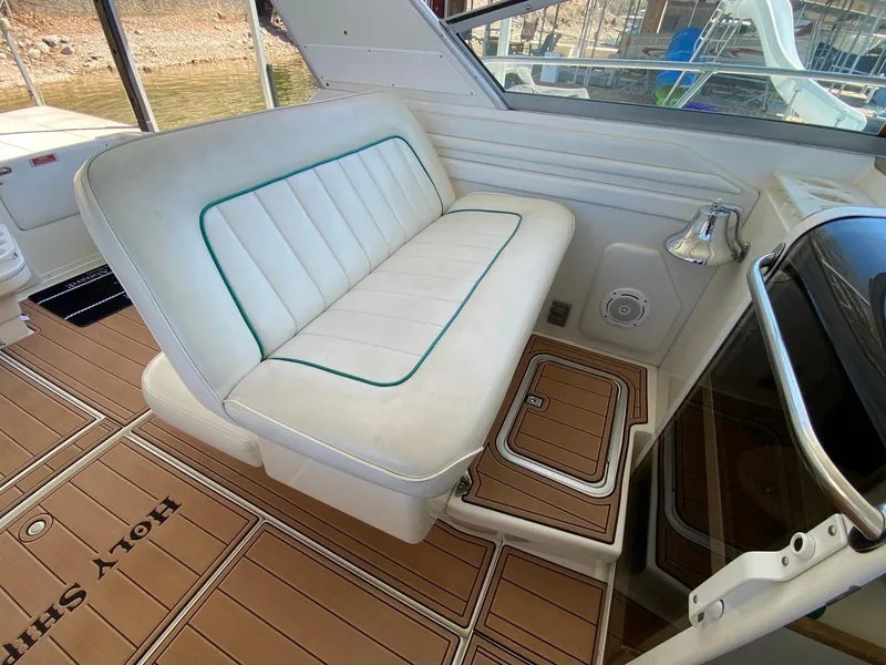 Slide: The Image of 1995 Sea Ray 400 Express Cruiser interior with white seating and teak flooring. - 13