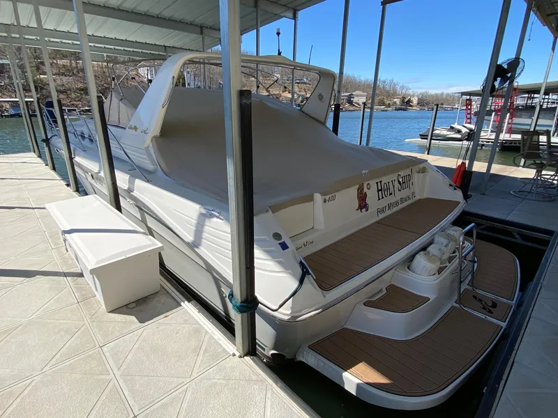 Slide: The Image of 1995 Sea Ray 400 Express Cruiser docked under a covered marina. - 2