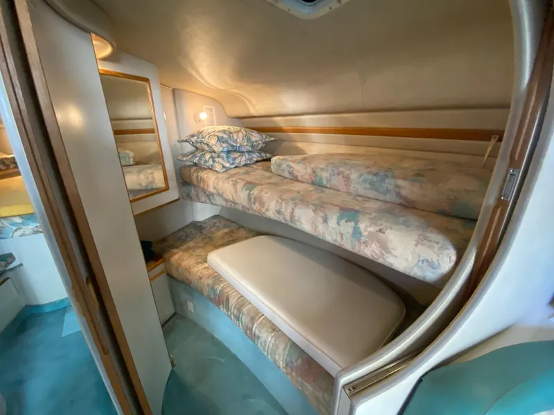 Slide: The Image of 1995 Sea Ray 400 Express Cruiser cabin with bunk beds and cozy interior. - 20