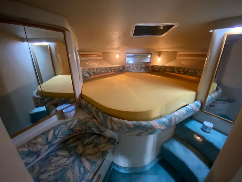Slide: The Image of Interior of 1995 Sea Ray 400 Express Cruiser with cozy bed and ambient lighting. - 22