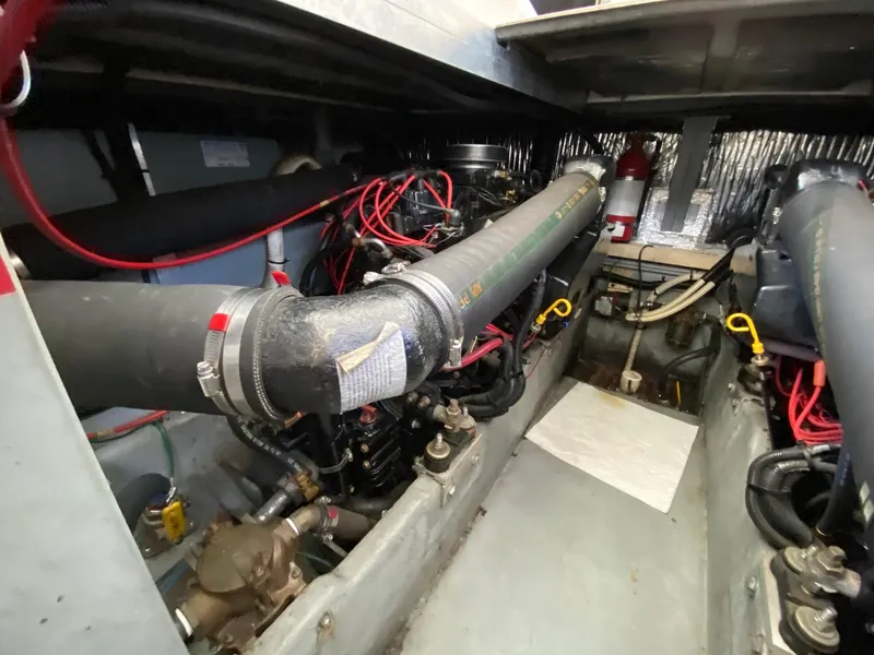 Slide: The Image of Engine compartment of a 1995 Sea Ray 400 Express Cruiser with visible hoses and wiring. - 23