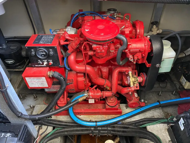 Slide: The Image of Engine compartment of a 1995 Sea Ray 400 Express Cruiser, featuring a red marine engine. - 25