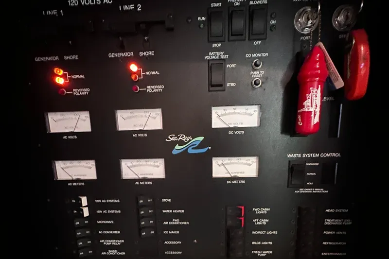 Slide: The Image of Control panel of a 1995 Sea Ray 400 Express Cruiser with gauges and switches. - 28