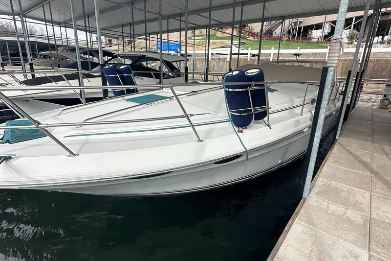 Slide: The Image of 1995 Sea Ray 400 Express Cruiser docked in a covered marina. - 3