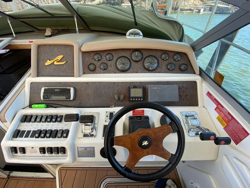 Slide: The Image of 1995 Sea Ray 400 Express Cruiser dashboard with steering wheel and control panel. - 7
