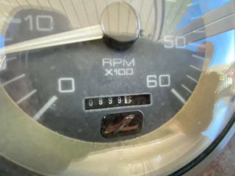 Slide: The Image of 1995 Sea Ray 400 Express Cruiser RPM gauge displaying 899 hours. - 9