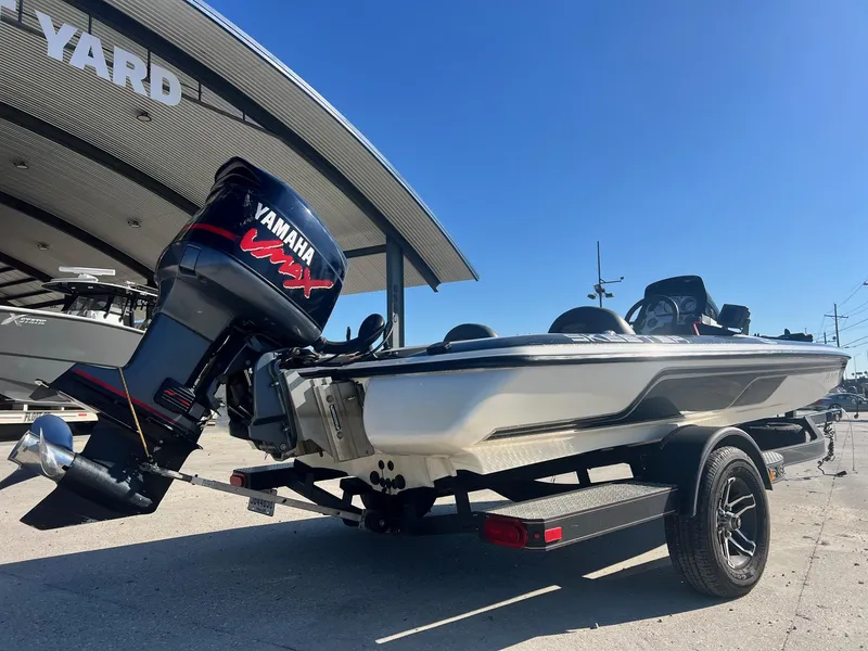 Slide: The Image of 2007 Skeeter ZX 190 boat with Yamaha engine, parked at a boatyard under clear blue sky. - 7