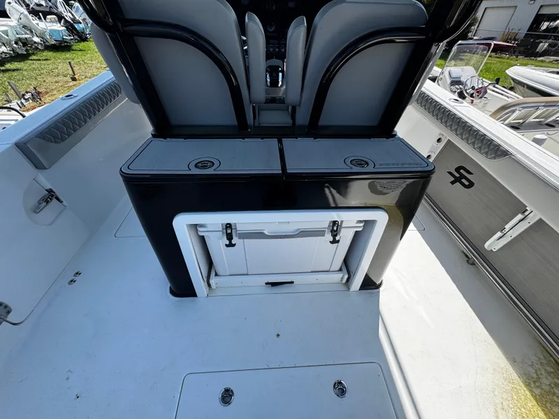 Slide: The Image of 2023 Sea Pro 320 DLX Center Console boat interior with seating and storage compartments. - 13