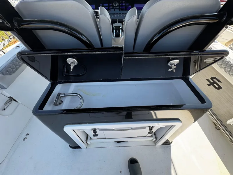 Slide: The Image of 2023 Sea Pro 320 DLX Center Console with built-in sink and storage compartment. - 14
