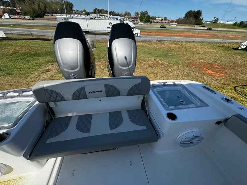 Slide: The Image of 2023 Sea Pro 320 DLX Center Console boat with dual engines and seating area. - 17