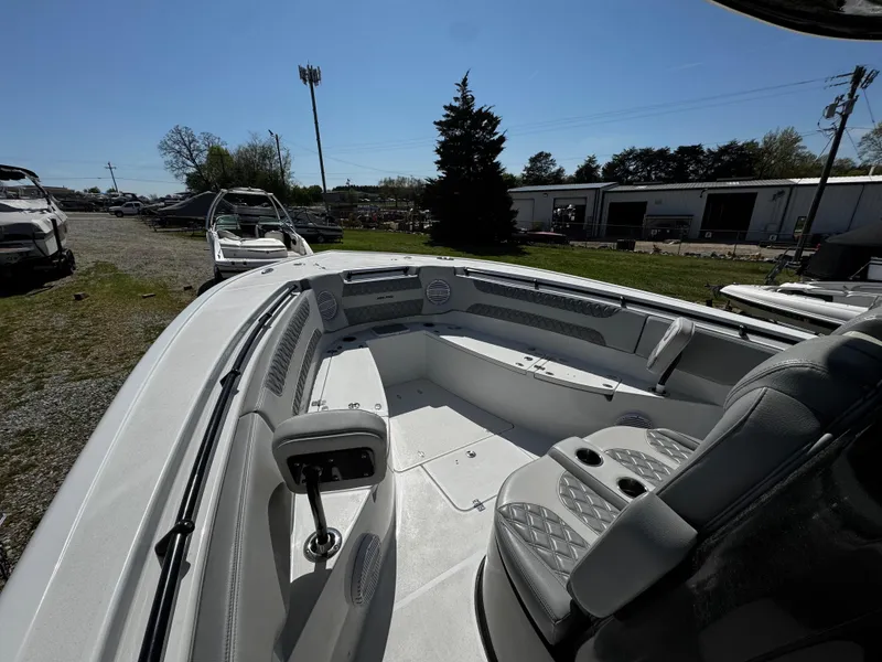 Slide: The Image of 2023 Sea Pro 320 DLX Center Console boat interior with seating and console, outdoor setting. - 4