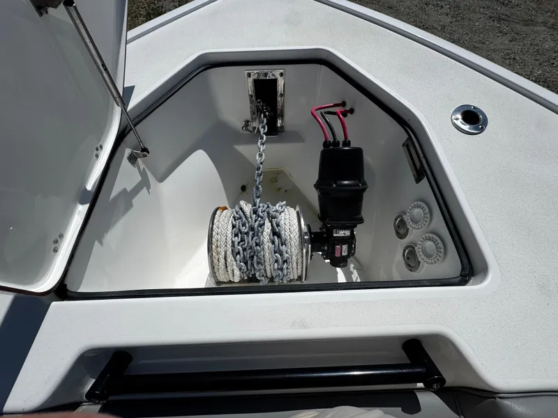 Slide: The Image of 2023 Sea Pro 320 DLX Center Console anchor storage with chain and winch system. - 5