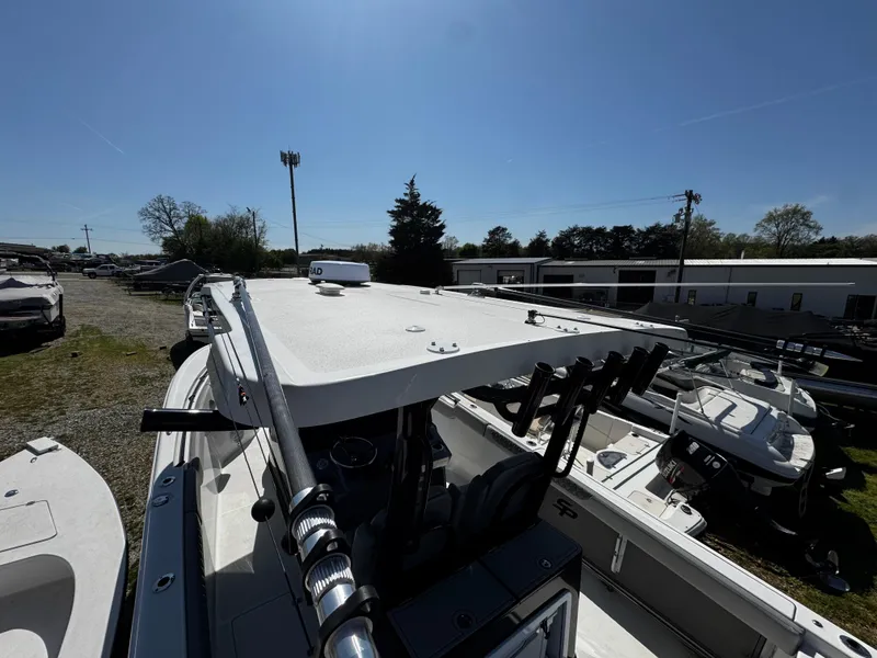 Slide: The Image of 2023 Sea Pro 320 DLX Center Console boat, top view, parked outdoors under clear sky. - 8