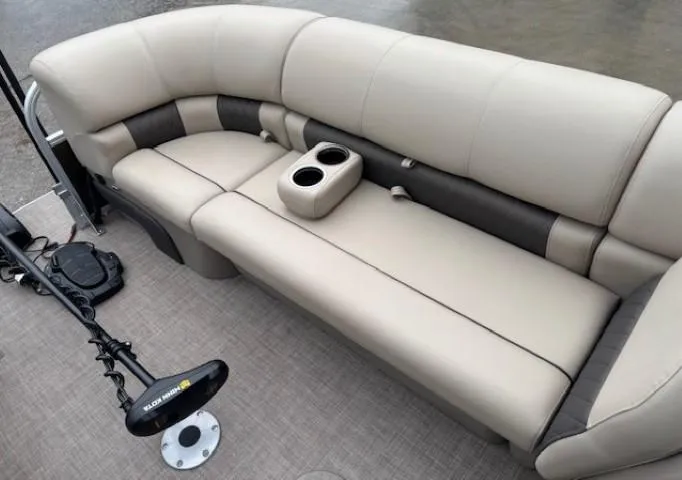 Slide: The Image of 2022 Sun Tracker SportFish 22 XP3 boat interior with beige seating and cup holders. - 10
