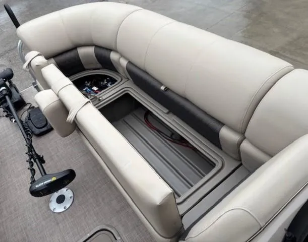 Slide: The Image of 2022 Sun Tracker SportFish 22 XP3 boat interior with beige seating and storage compartment. - 11