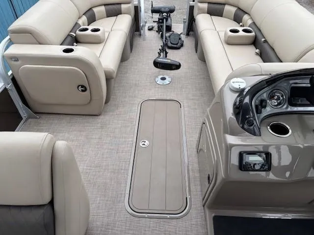 Slide: The Image of 2022 Sun Tracker SportFish 22 XP3 interior with beige seating and modern dashboard. - 16