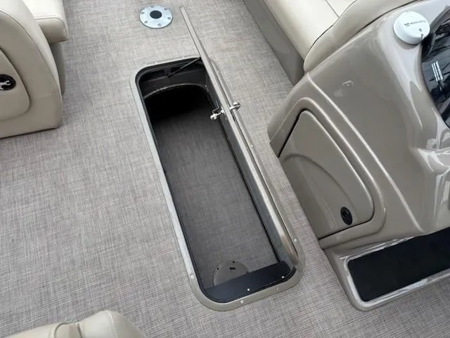 Slide: The Image of 2022 Sun Tracker SportFish 22 XP3 boat interior with open storage compartment. - 17