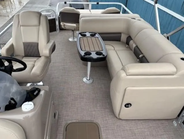 Slide: The Image of 2022 Sun Tracker SportFish 22 XP3 pontoon boat interior with beige seating and table. - 24