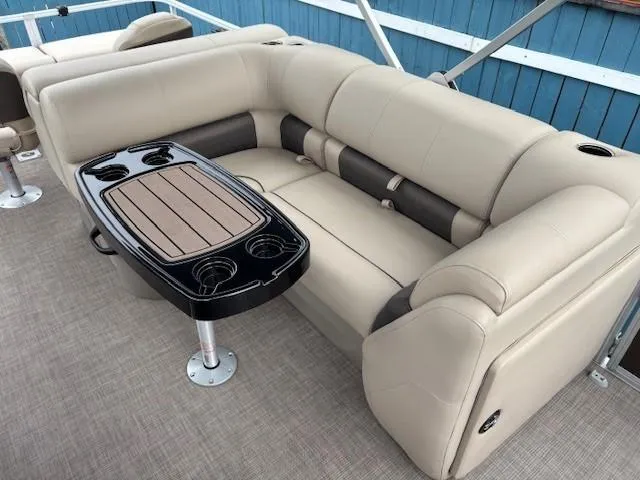 Slide: The Image of Luxurious seating on 2022 Sun Tracker SportFish 22 XP3 pontoon boat with table and cup holders. - 25