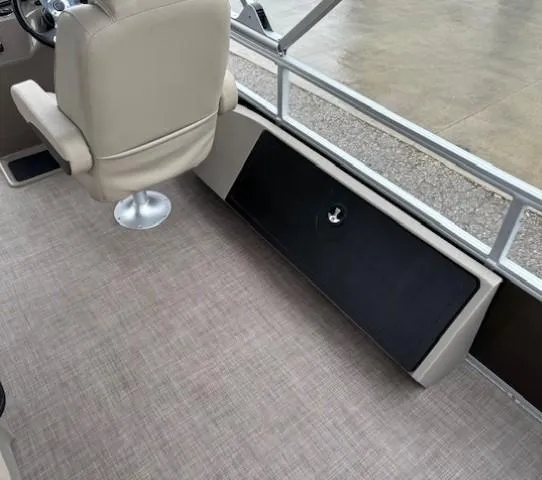 Slide: The Image of 2022 Sun Tracker SportFish 22 XP3 interior with beige seating and storage compartment. - 29