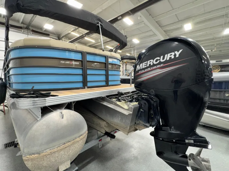 Slide: The Image of 2019 Crest III 240 SLE pontoon boat with Mercury outboard motor in showroom. - 19