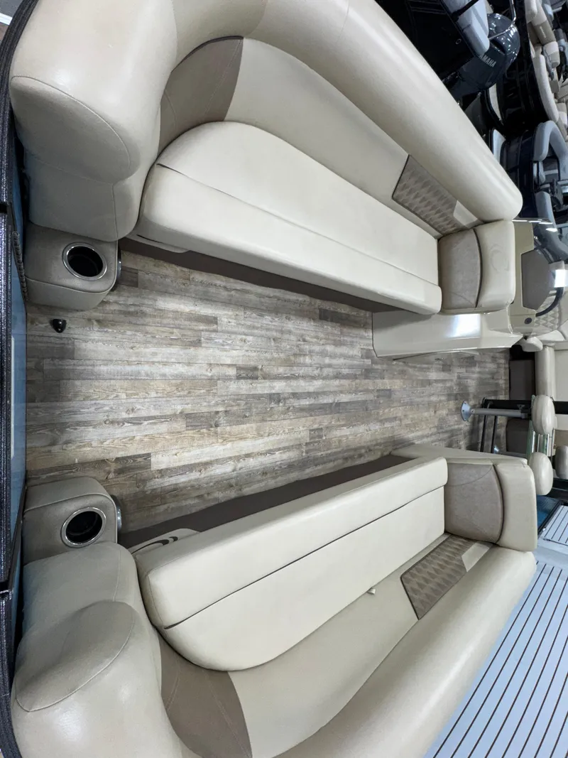 Slide: The Image of 2019 Crest III 240 SLE boat interior with beige seating and wood-style flooring. - 22